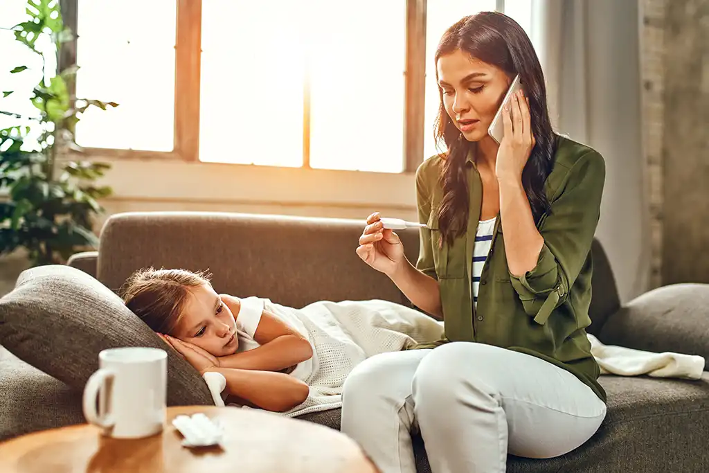 mom taking daughters temperature