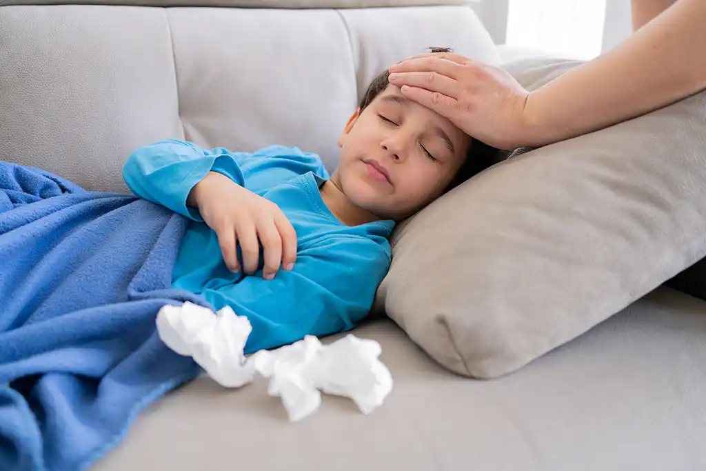 little boy on the couch feeling sick