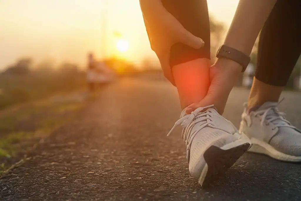 runner holding injured ankle